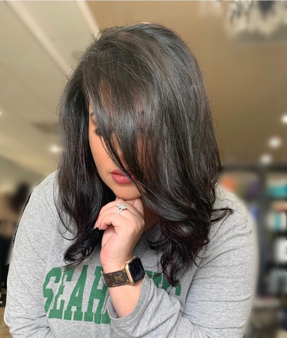 Glossy dark layered lob with soft curls